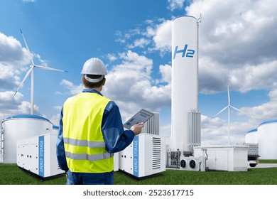 Engineer with tablet computer on a background of Hydrogen factory	.