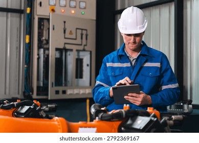 Engineer tablet factory automation robot industry inspection maintenance worker focused on digital tablet in modern factory controlling automation robot and checking industry equipment safety