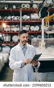 Engineer With Tablet Working At Polymer Factory Warehouse