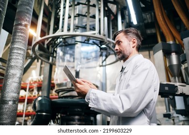 Engineer With Tablet Working At Polymer Factory