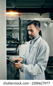 Engineer With Tablet Working At Polymer Factory