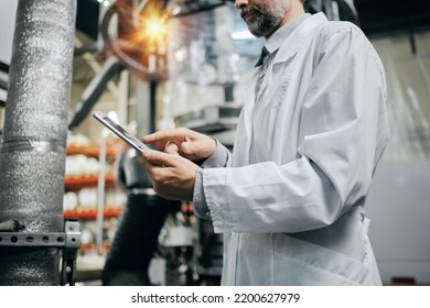 Engineer With Tablet Working At Polymer Factory