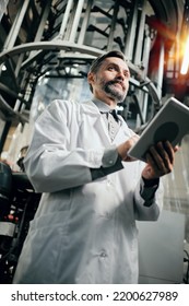 Engineer With Tablet Working At Polymer Factory