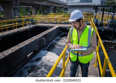 Engineer take water from  wastewater treatment pond to check the quality of the water. After going through the wastewater treatment process. - Shutterstock ID 2120040551