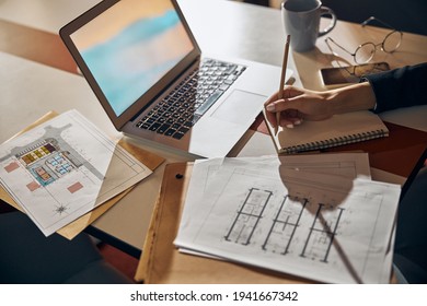 Engineer taking notes with a pencil at the desk