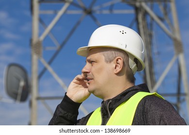 Engineer Talking On The Cell Phone Near To Gsm Tower