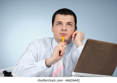 An engineer talking on his mobile phone on gray background