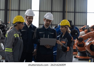 Engineer team, Automatic robotics arms in storage warehouse. Engineer team disccussing for installation, testing or setting robotics arms