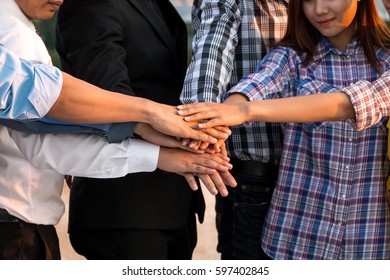 Engineer team with helmet and showing unity by hands with construction site background. - Shutterstock ID 597402845
