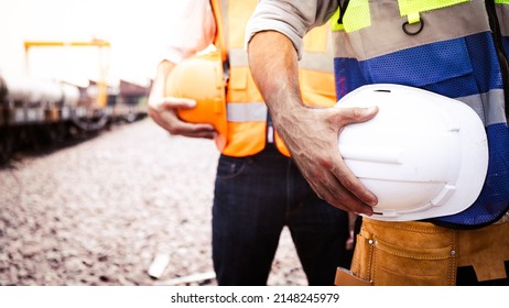 Engineer team holding hardhat Logistic expert by railway.Worker diversity group wearing vest,ppe for safety in site train garage.Expert construction project manager leadership.banner cover design.