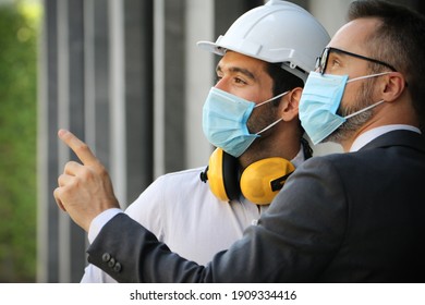 Engineer Team Meeting And Discussion About Solar Roof Project Installation With Site Manager, They Wear Face Mask Covid-19 Protection