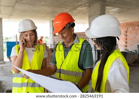 Engineer team studies blueprint while woman uses phone beside supervisor. Foreman points detail and assigns task steps before work starts