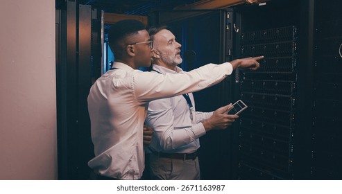 Engineer, team or tablet with pointing in server room for software upgrade, solution and IT support. People, digital app and inspection at data center for network backup, GDPR and hardware management