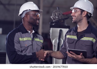 Engineer team use remote controller and tablet control, testing  Artificial Intelligent welding robotic automatic arm machine in modern factory. Automation manufacturing for industry 4.0 Technology. 