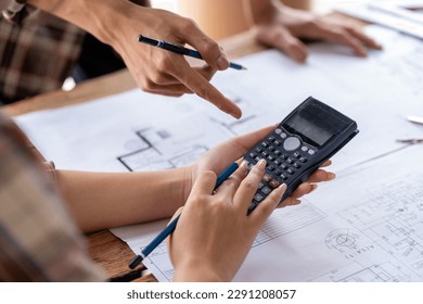engineer team working in the office, engineer and architect use calculator for calculate drawing design construction, engineer discussion and estimate the cost of project
