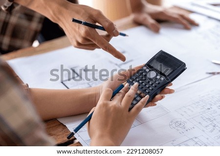 engineer team working in the office, engineer and architect use calculator for calculate drawing design construction, engineer discussion and estimate the cost of project