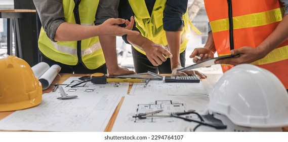 Engineer Teamwork Meeting, Drawing working on blueprint meeting for project working with partner on model building and engineering tools in working site, Construction and structure concept.. - Powered by Shutterstock