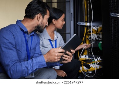 Engineer teamwork, server room and tablet for connection cable, maintenance or software update at night. Cybersecurity wire, programmers or man and woman with technology for networking in data center