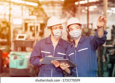 Engineer teamwork worker wearing disposable face mask or face shield during working in factory to prevent Covid-19 virus air dust pollution and for good hygiene. - Powered by Shutterstock