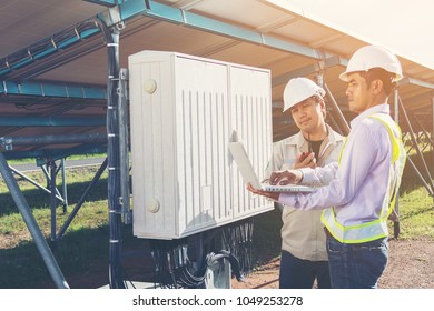 engineer and technician checking efficiency of solar panel at solar power plant ; expertise service team working on measuring efficiency of operation and maintenance at solar plant 
