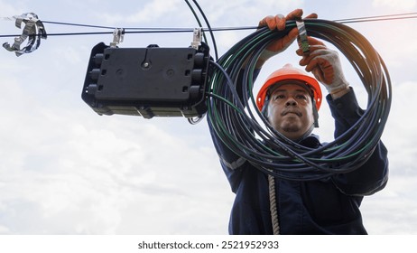 Engineer or technician checking fiber optic cables in internet splitter box.Fiber to the home equipment. FTTH internet fiber optics cables and cabinet.	
