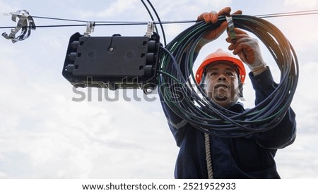 Engineer or technician checking fiber optic cables in internet splitter box.Fiber to the home equipment. FTTH internet fiber optics cables and cabinet.	