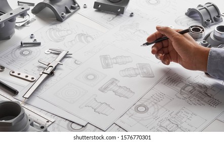 Engineer Technician Designing Drawings Mechanical parts Engineering Engine
Manufacturing Factory Industry Industrial Work Project Blueprints Measuring Bearings Caliper Tools