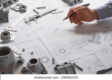 Engineer technician designing drawings mechanical parts engineering Engine
manufacturing factory Industry Industrial work project blueprints measuring bearings caliper tools                            - Shutterstock ID 1584361315