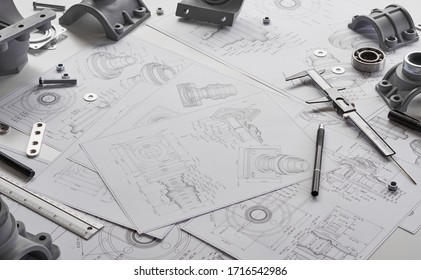 Engineer Technician Designing Drawings Mechanical parts Engineering Engine
Manufacturing Factory Industry Industrial Work Project Blueprints Measuring Bearings Caliper Tool.