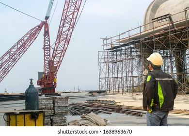 Engineer technician and helmet. T-shirt stands over the building in the construction zone. - Shutterstock ID 1638963670