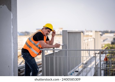 Engineer technician inspecting the structure is taking a break because he is tired from unfinished construction work. due to hot weather or work outdoors