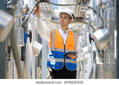 Engineer or technician looking above and checking air conditioner control valve at plumbing systems