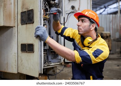 engineer or technician operating industrial control panel in the factory