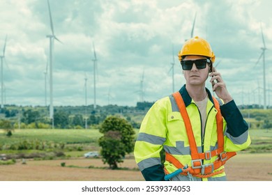 Engineer technician phone calling at Wind Turbines working service at wind electricity generator farm field. - Powered by Shutterstock