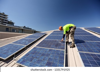 Engineer Technician Wearing A Safety Helmet Long Sleeve Shirt Conducting Safety Inspecting Roof Power Sola Cell Damage Glass Panel  Building Site Sydney, Australia  