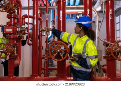 Engineer or technician work checking Fire suppression system and fire equipment. Engineer check red generator pump for water sprinkler piping and fire alarm control system