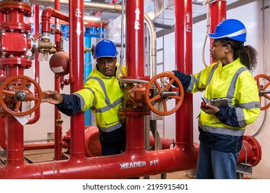 Engineer Or Technician Work Checking Fire Suppression System And Fire Equipment. Engineer Check Red Generator Pump For Water Sprinkler Piping And Fire Alarm Control System