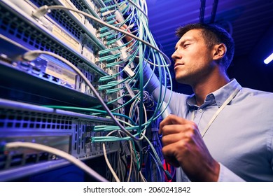 Engineer Testing Cable Connections On Network Server