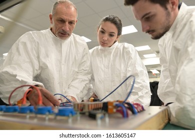 Engineer with trainees in microelectronics industry