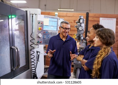 Engineer Training Apprentices On CNC Machine - Powered by Shutterstock