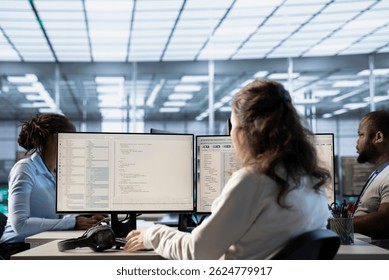 Engineer typing on computer in server hub, checking recovery plan, monitoring data center energy consumption, solving tasks. Technician inspecting rackmounts in data center