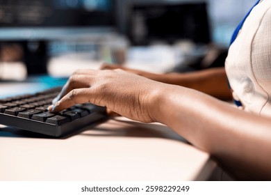 Engineer typing on keyboard, reconfiguring server farm to optimize it for data processing requirements of customers. Close up of employee working on PC to ensure data center operates efficiently
