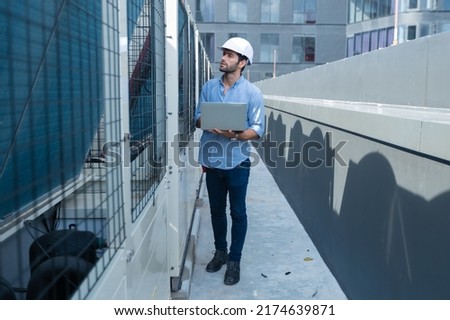 Engineer under checking the industry chilled water fan coil unit air conditioner is water cooling tower air chiller HVAC system of large industrial building to control air system 