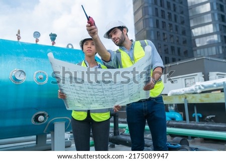 Engineer under checking the industry chilled water fan coil unit air conditioner is water cooling tower air chiller HVAC system of large industrial building to control air system
