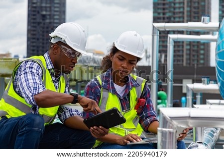 Engineer under checking the industry chilled water fan coil unit air conditioner is water cooling tower air chiller HVAC system of large industrial building to control air system