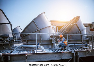 Engineer under checking the industry cooling tower air conditioner is water cooling tower air chiller HVAC of large industrial building to control air system. - Shutterstock ID 1724378674