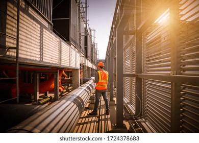 Engineer under checking the industry cooling tower air conditioner is water cooling tower air chiller HVAC of large industrial building to control air system.