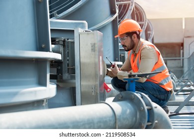 Engineer under checking the industry cooling tower air conditioner is water cooling tower air chiller HVAC of large industrial building to control air system. - Shutterstock ID 2119508534