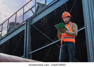 Engineer under checking the industry cooling tower air conditioner is water cooling tower air chiller HVAC of large industrial building to control air system. - Shutterstock ID 2164719053