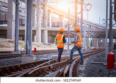 Engineer under discussion inspection and checking construction process railway switch and checking work on railroad station .Engineer wearing safety uniform and safety helmet in work. - Shutterstock ID 1812749569